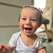 Eleanor joined the competition — help win amazing prizes! toddler, child, smiling, happy, face, hair_clip, indoor, white_shirt, cute, baby, portrait, laughing, skin, person, young_child, short_hair, cheerful, expression, infant, blurry_background