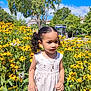 child, girl, flower_garden, yellow_flowers, white_dress, curly_hair, pigtails, outdoor, nature, sunny, greenery, portrait, summer, blue_sky, trees, necklace, young, innocent, daylight, plants