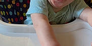 Brooklyn is registered to the contest to win money with this photo: baby, babylaughing, bodypart, chair, clothing, crib, cutlery, face, furniture, happy, head, laughing, mouth, person, photography, portrait, smile, spoon, t_shirt, teeth
