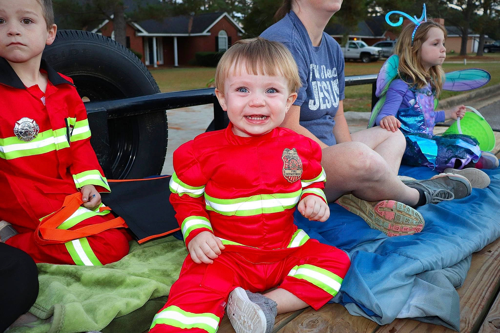 Grayson is registered to the contest to win money with this photo: child, event, fictional_character, fun, grass, happy, head, holiday, joy, lap, leisure, person, product, recreation, shorts, sitting, smile, social_group, sorrow, tire