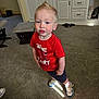 Kaiser joined the competition — help win amazing prizes! toddler, child, indoor, carpet, red_shirt, sneakers, shorts, hair, mohawk, living_room, cabinet, furniture, pose, curious, young_child, person, floor, light_spot, casual_clothing, home