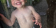 Kaiser is registered to the contest to win money with this photo: toddler, child, smiling, diaper, glass, door, reflection, garden, outdoor, indoor, happy, barefoot, messy, curious, playful, face, hand, window, foot, portrait