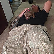 Daisy joined the competition — help win amazing prizes! puppy, dog, sleeping, person, tattoo, blanket, carpet, indoors, home, nap, pet, animal, brown_dog, collar, pink_collar, human, lying_down, cozy, stroller, doorway