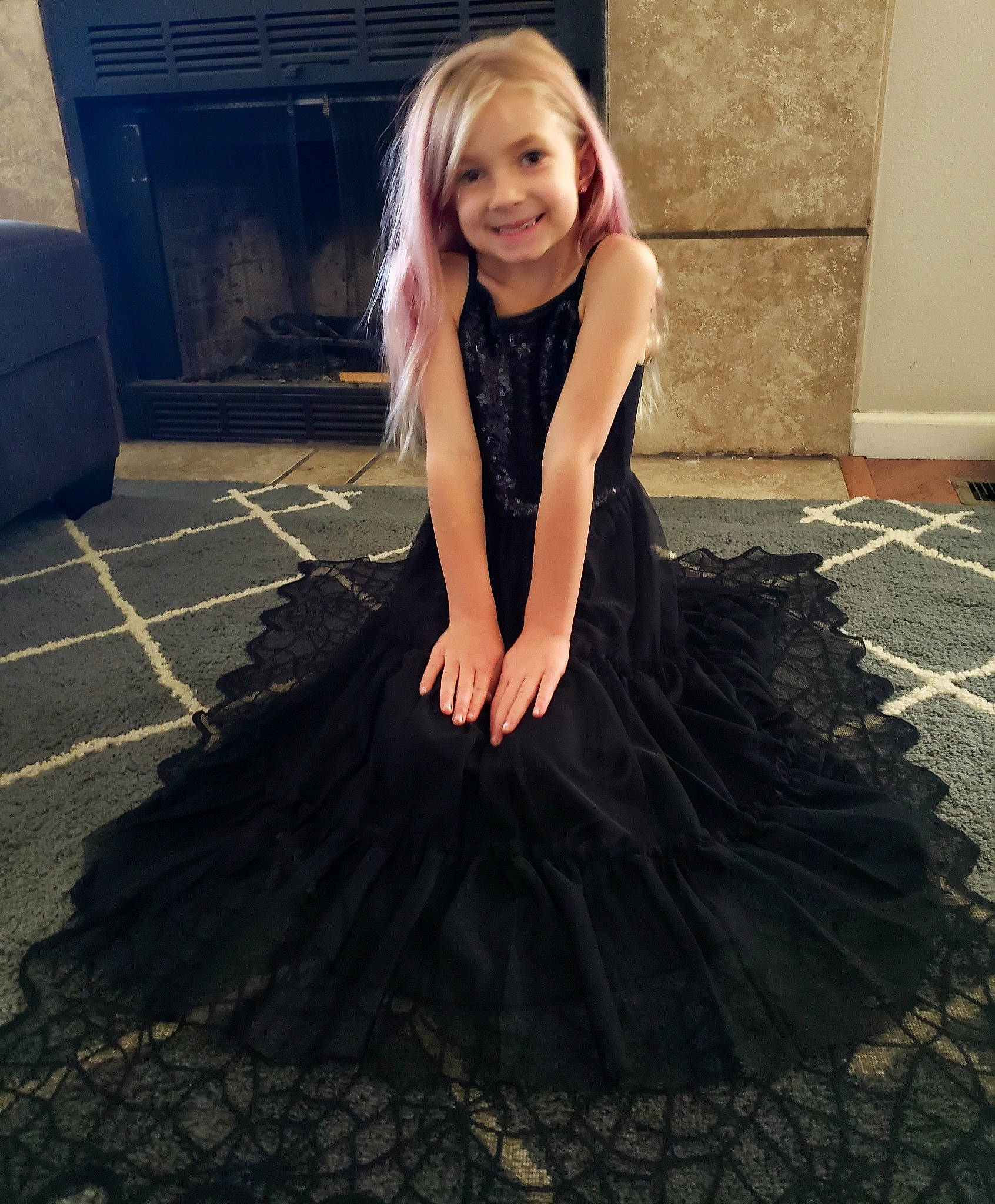Skarlett is registered to the contest to win money with this photo: blond, dress, embellishment, event, face, fashion_design, flash_photography, flooring, formal_wear, hair, joy, long_hair, pattern, person, ruffle, shoulder, sleeve, smile, tints_and_shades, toddler