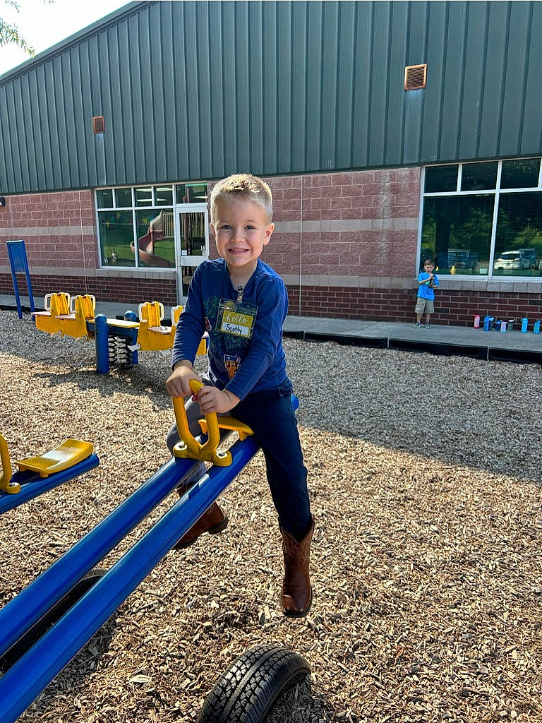 Scotty joined the competition — help win amazing prizes! asphalt, automotive_tire, building, child, city, electric_blue, fun, grass, joy, leisure, outdoor_play_equipment, person, playground, recreation, rolling, sky, smile, soil, tire, toddler