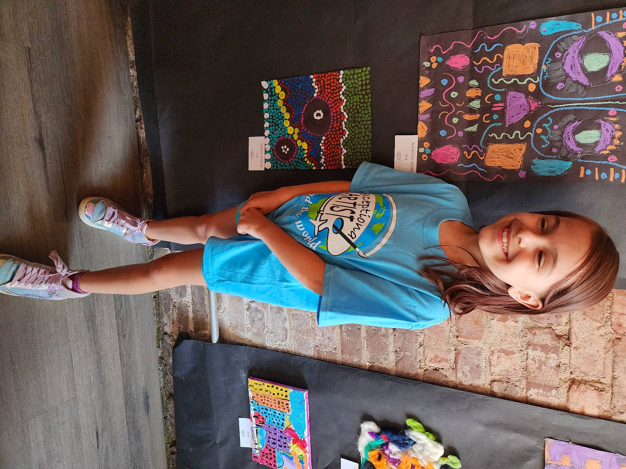 Isabella joined the competition — help win amazing prizes! art, child, electric_blue, foot, fun, happy, human_leg, joy, knee, leisure, linens, pattern, person, room, sandal, sitting, smile, t_shirt, thigh, vacation