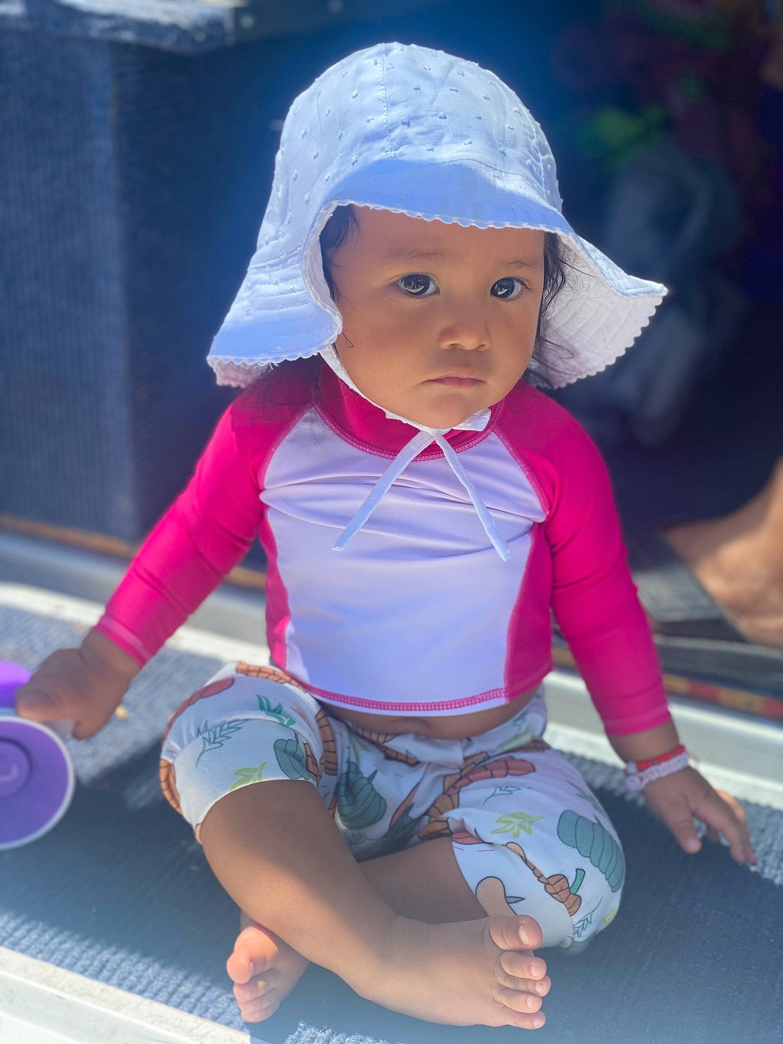 Camila is registered to the contest to win money with this photo: arm, baby, baby_toddler_clothing, cap, cool, electric_blue, facial_expression, fun, happy, headgear, headwear, leg, leisure, person, pink, product, purple, recreation, skin, sleeve