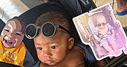 Dax is registered to the contest to win money with this photo: baby, infant, child, stroller, sunglasses, portrait, seated, indoor, floor, cartoon, printed_card, text_overlay, obsessed, fashion, cute, serious_expression, black_clothing, close_up, wheel, photography