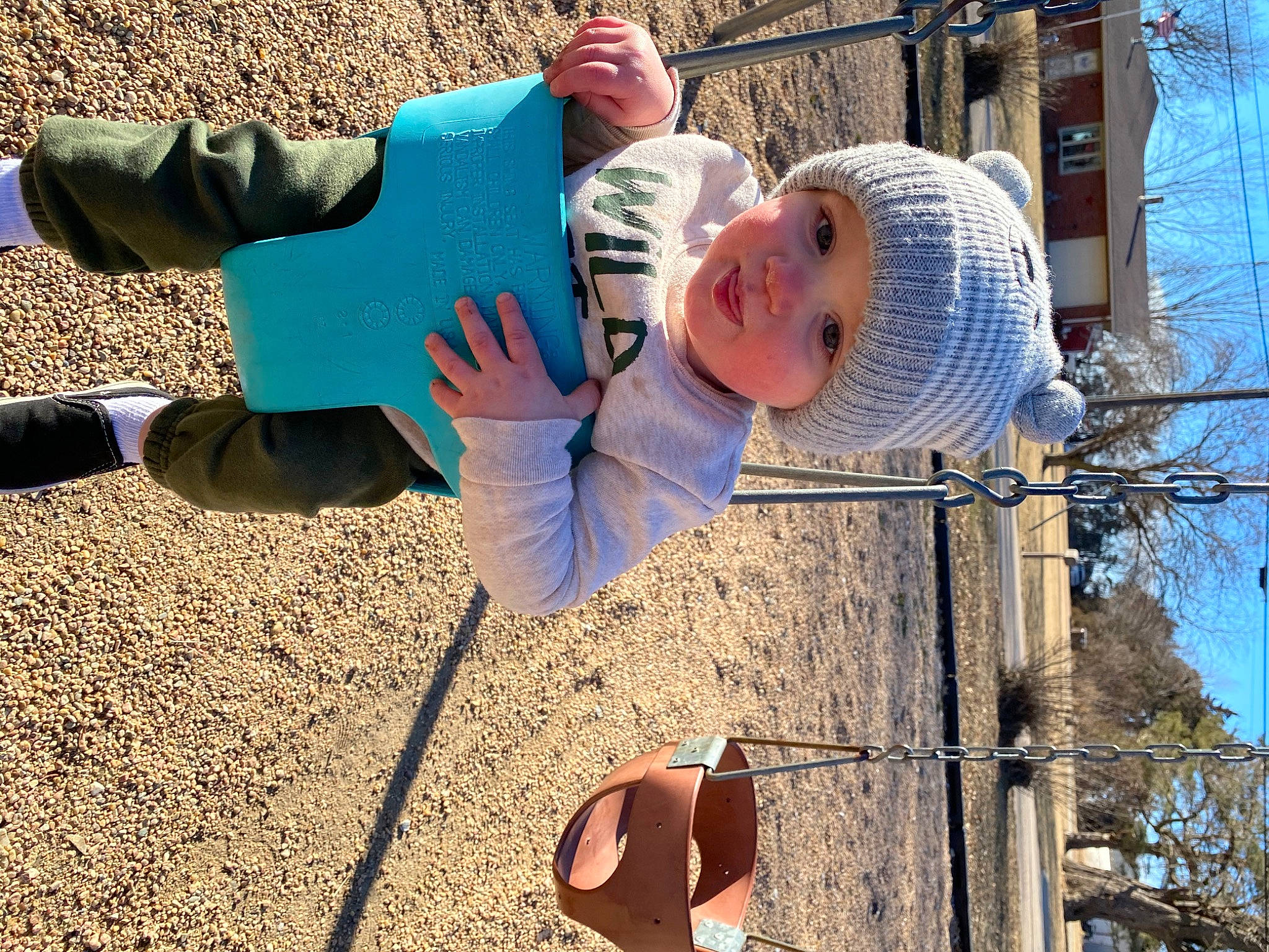 Brentley is registered to the contest to win money with this photo: city, electric_blue, foot, fun, grass, happy, hat, headwear, human_leg, leisure, people_in_nature, person, photograph, recreation, shoe, sitting, sky, soil, spring, toddler