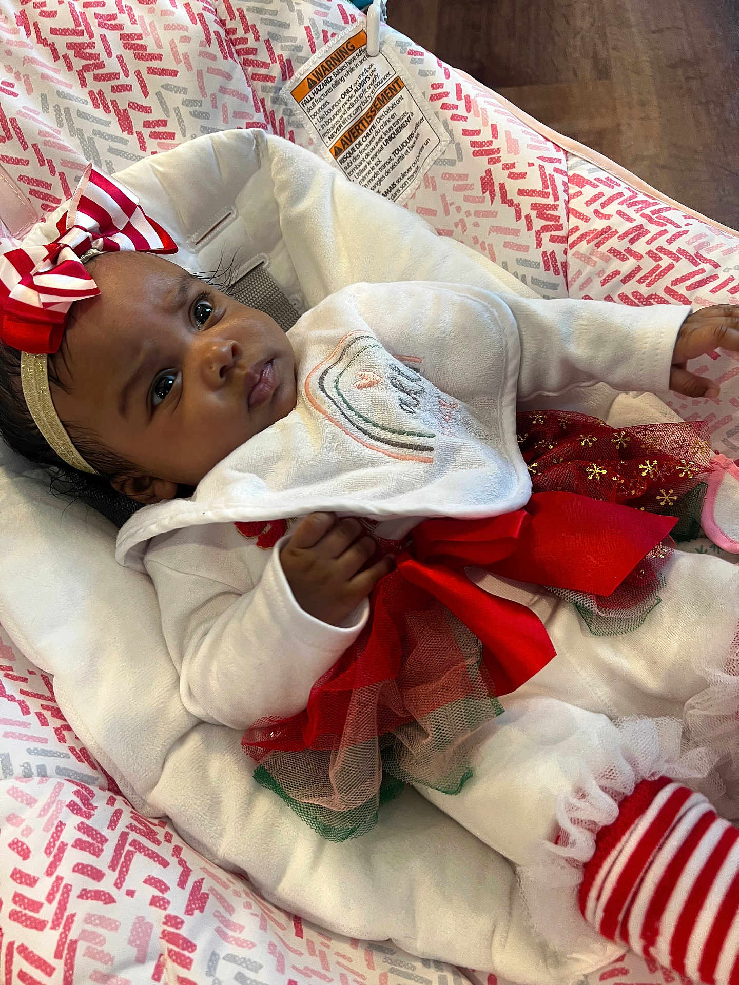 Yahrae joined the competition — help win amazing prizes! baby, infant, child, bow, headband, red_bow, white_outfit, tutu_skirt, striped_socks, cushion, patterned_fabric, indoor, portrait, cute, holiday_outfit, closeup, person, newborn, soft_texture, comfortable