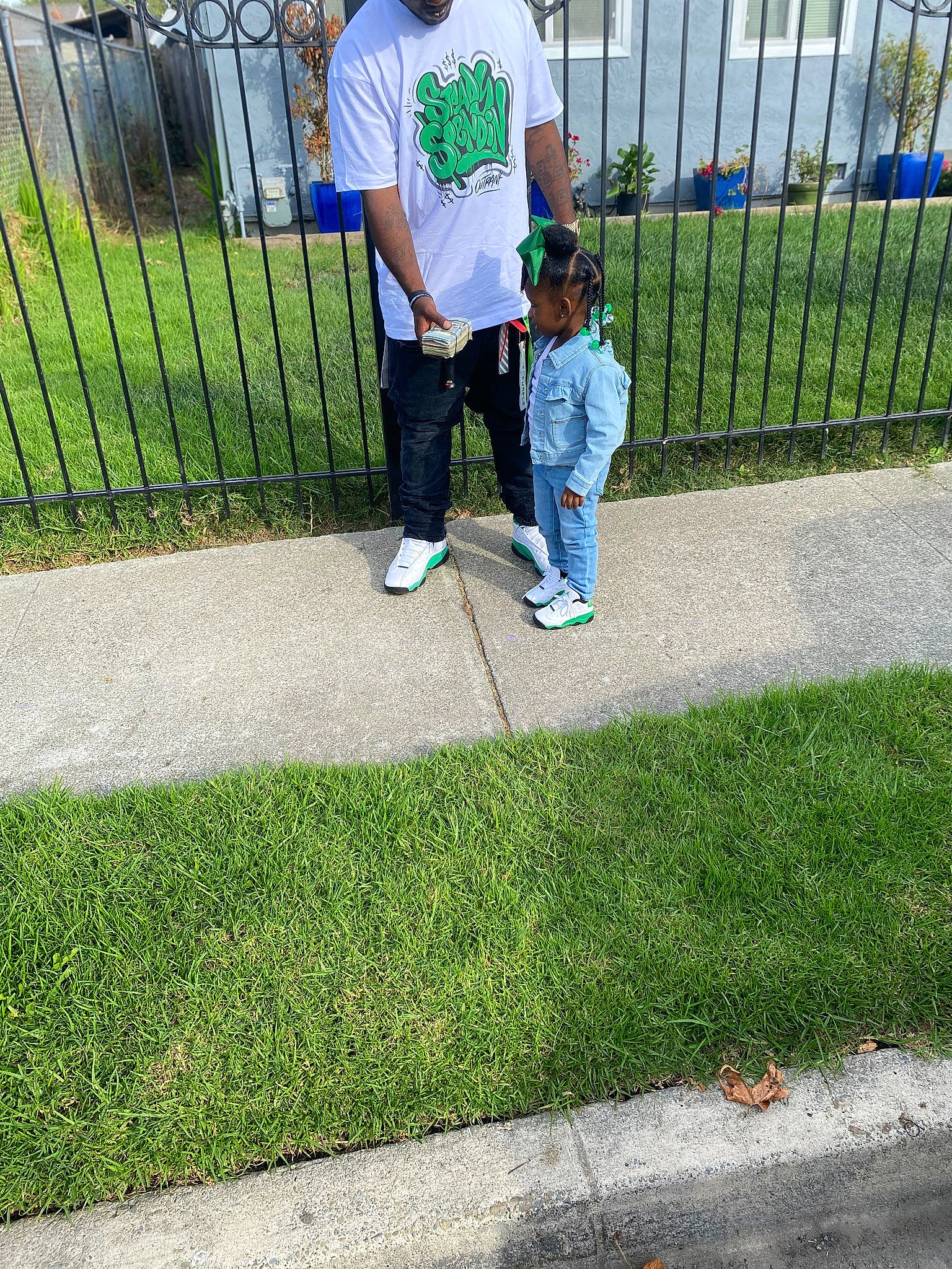 Kalayah is registered to the contest to win money with this photo: asphalt, chain_link_fencing, city, denim, fence, fun, garden, grass, home_fencing, lawn, leisure, mesh, person, recreation, road_surface, sidewalk, sneakers, toddler, walking, walkway