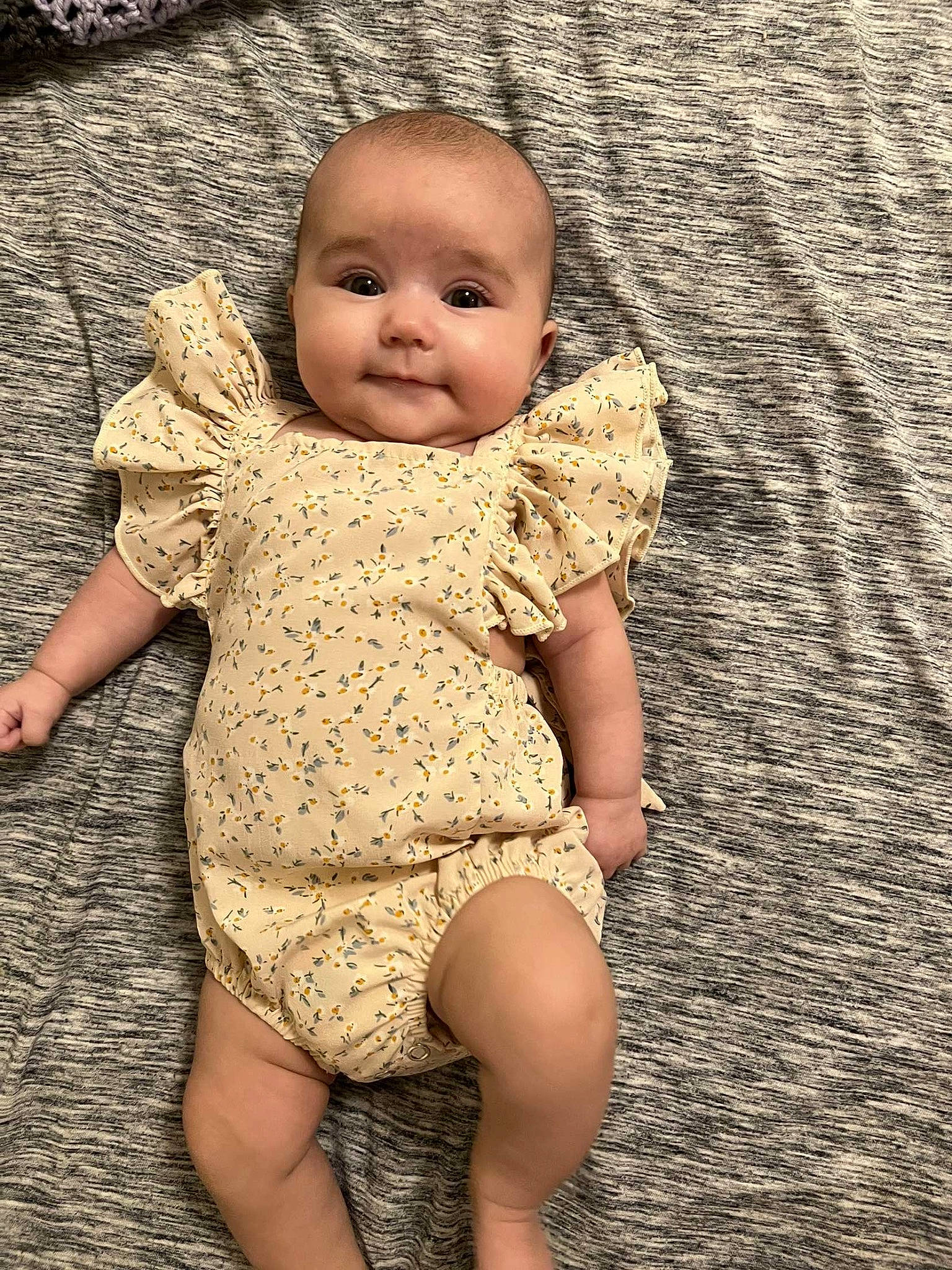 Gracelynn is registered to the contest to win money with this photo: baby, baby_toddler_clothing, eye, face, finger, floor, flooring, foot, gesture, grass, hand, happy, human_leg, people_in_nature, person, road_surface, skin, thigh, toddler, waist