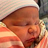 Hailey is registered to the contest to win money with this photo: newborn, baby, sleeping, blanket, striped_hat, infant, closeup, wrapped, peaceful, soft, face, child, cute, portrait, indoors, resting, newborn_clothing, warm, baby_swaddle, headwear