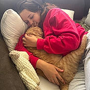 Nugget is registered to the contest to win money with this photo: blanket, casual_clothing, cat, comfort, couch, cozy, embrace, feline, home, indoor, orange_tabby, person, pillow, red_sweatshirt, relaxing, resting, sleeping_cat, snuggling, soft_lighting, warm