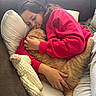 blanket, casual_clothing, cat, comfort, couch, cozy, embrace, feline, home, indoor, orange_tabby, person, pillow, red_sweatshirt, relaxing, resting, sleeping_cat, snuggling, soft_lighting, warm