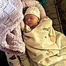 newborn, baby, sleeping, blanket, hat, baby_nest, plush_blanket, cozy, infant, soft, cute, peaceful, indoors, resting, child, wrapped, floral, fabric, comfort, peace