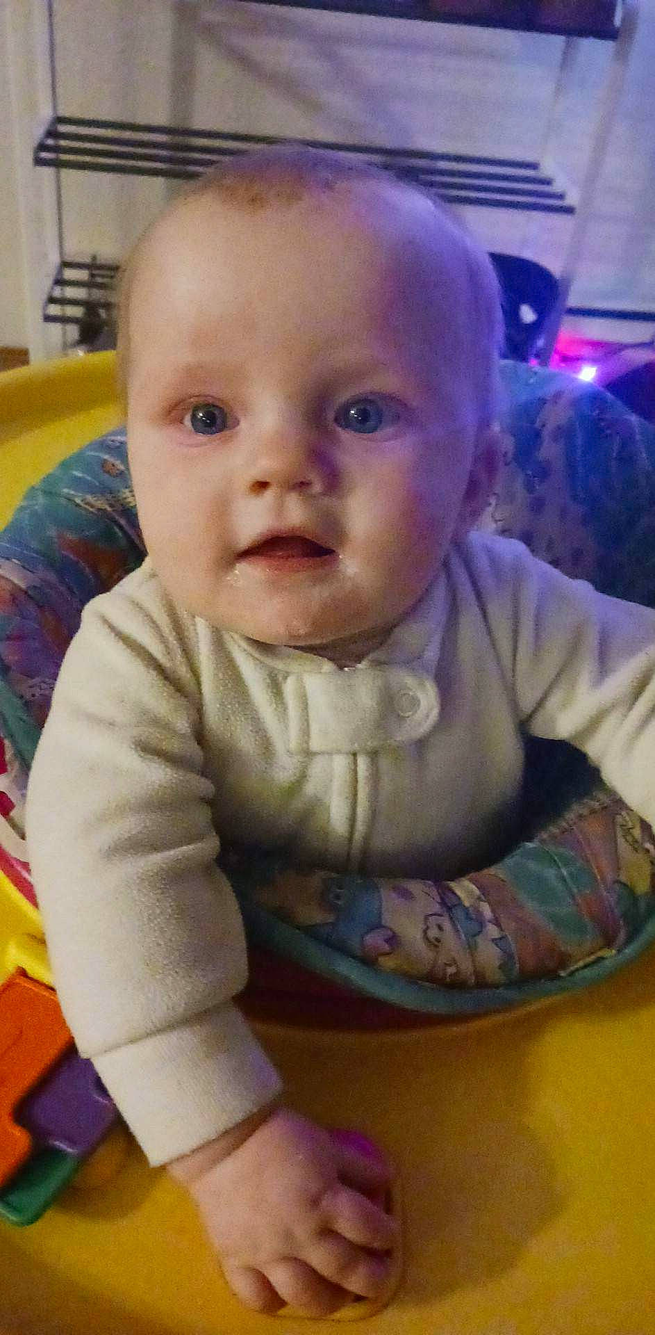 Nellie joined the competition — help win amazing prizes! baby, baby_products, baby_safety, baby_toddler_clothing, bib, cheek, child, comfort, eye, flooring, fun, head, iris, mouth, nose, person, sitting, skin, sleeve, toddler