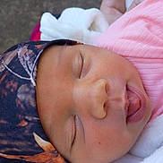 Ivey'Jade is registered to the contest to win money with this photo: newborn, baby, sleeping, portrait, close_up, face, headscarf, pink_clothing, blanket, infant, eyes_closed, tongue, peaceful, cozy, indoors, soft_fabric, cuddled, cute, resting, child