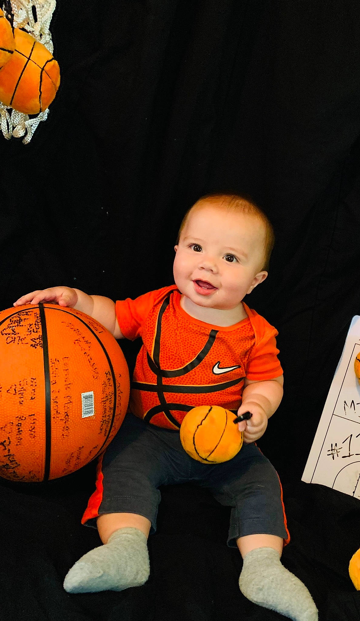 Marco Antonio Ill is registered to the contest to win money with this photo: baby, ball, ball_game, basketball, football, fun, happy, joy, knee, orange, person, personal_protective_equipment, player, room, shorts, smile, sports_equipment, sports_toy, sportswear, t_shirt