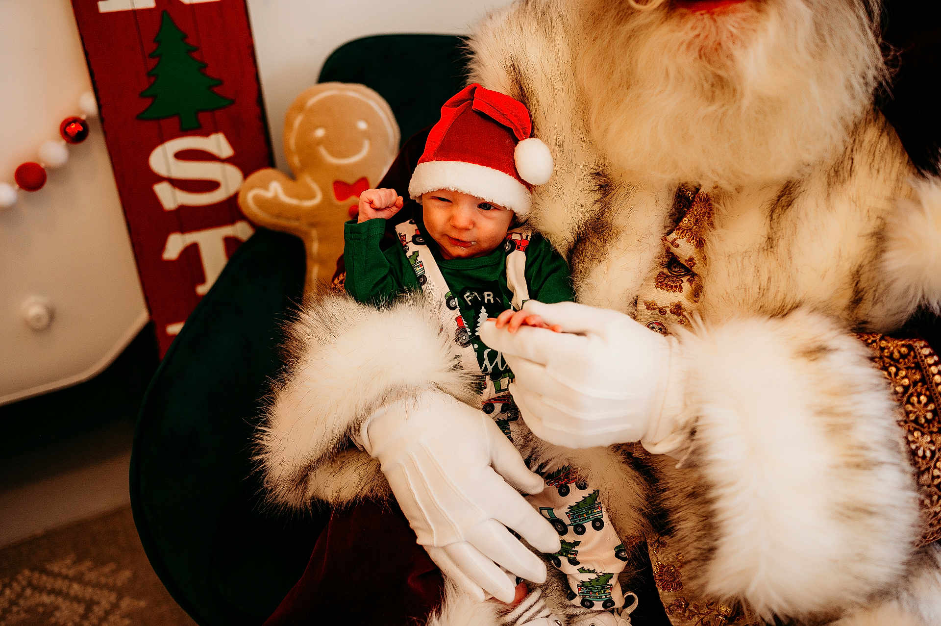 Bryer joined the competition — help win amazing prizes! infant, child, santa, beard, santa_hat, gloves, fur_trim, gingerbread, holiday_decor, christmas_sign, green_outfit, chair, indoor, portrait, festive, cozy, smile, baby_pose, seasonal, prop