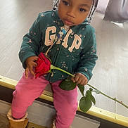 Jaiarie joined the competition — help win amazing prizes! beads, boots, braided_hair, calm, child, curtain, cute, floor, flower, gap, hoodie, indoor, person, pink_pants, rose, sitting, toddler, vent, window, young