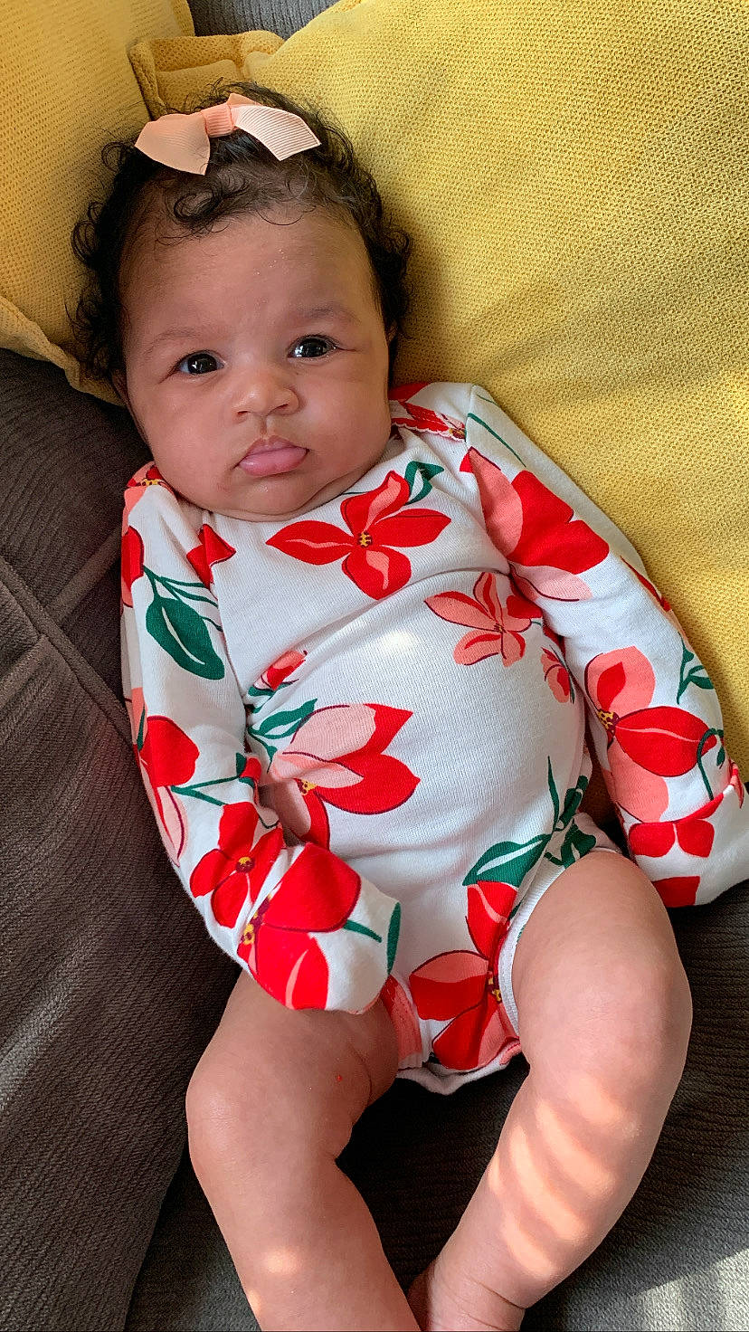 Isadora is registered to the contest to win money with this photo: baby, baby_toddler_clothing, cheek, chin, collar, comfort, eye, face, facial_expression, head, human_body, iris, lip, mouth, neck, person, skin, sleeve, textile, thigh