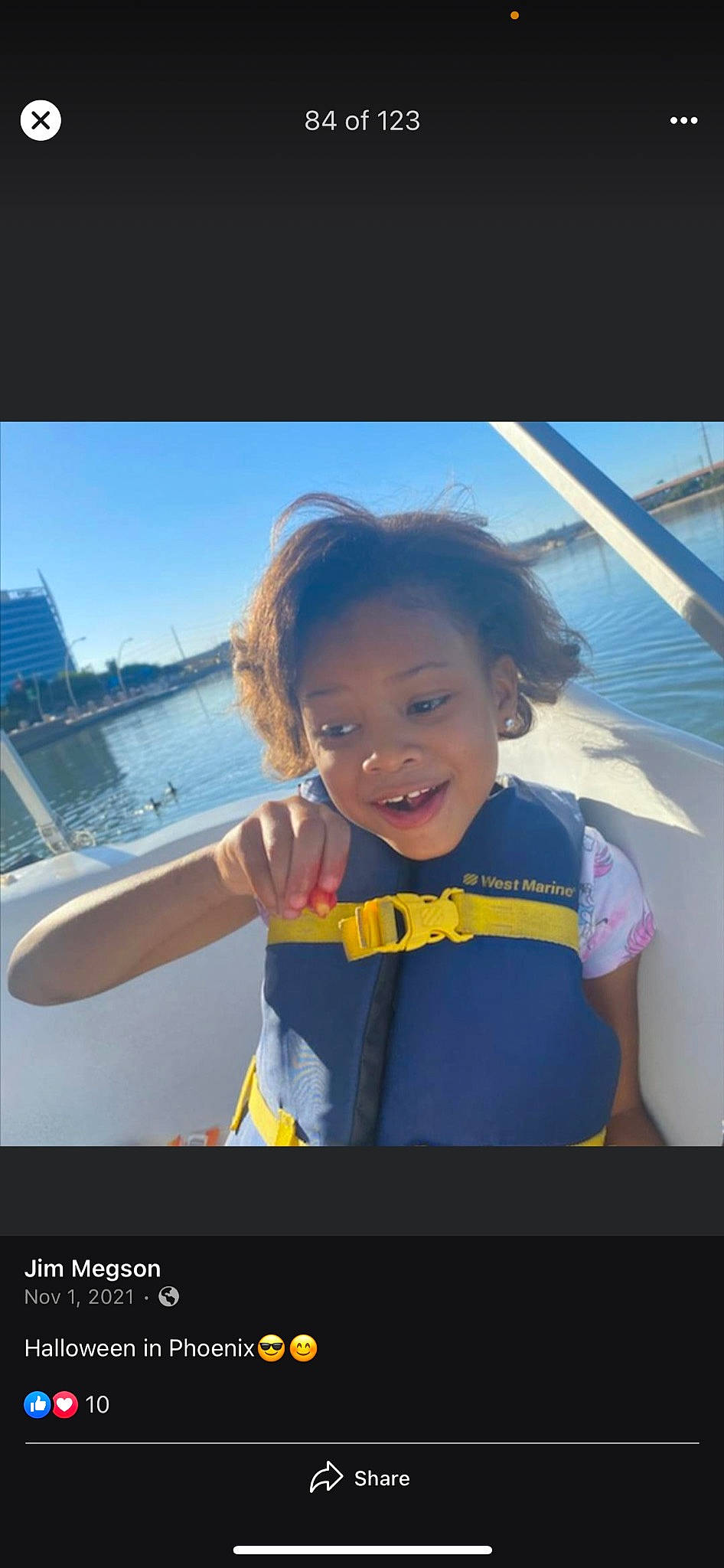 Dior is registered to the contest to win money with this photo: boat, boats_and_boating_equipment_and_supplies, building, electric_blue, eyewear, flash_photography, fun, happy, joy, lake, leisure, morning, person, personal_protective_equipment, recreation, sky, sleeve, smile, t_shirt, toddler