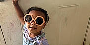 Annalynn is registered to the contest to win money with this photo: accessories, baby, bodypart, clothing, door, face, finger, glasses, hand, happy, head, pants, person, photography, portrait, sleeve, smile, sunglasses, t_shirt, undershirt