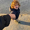 Lyam a rejoint le concours — aidez-le/la à gagner de superbes lots ! child, curly_hair, holding_hands, jacket, sneakers, pavement, shadow, outdoor, person, sidewalk, sunlight, street, walking, happy, casual_clothing, young_child, urban, daylight, curly_hair_child, hand_holding