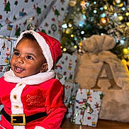 Baby Bear joined the competition — help win amazing prizes! baby, child, santa_suit, christmas, holiday, festive, tree, lights, ornaments, presents, gift_wrap, smiling, happy, indoor, celebration, cute, seasonal, portrait, holiday_decor, festivity