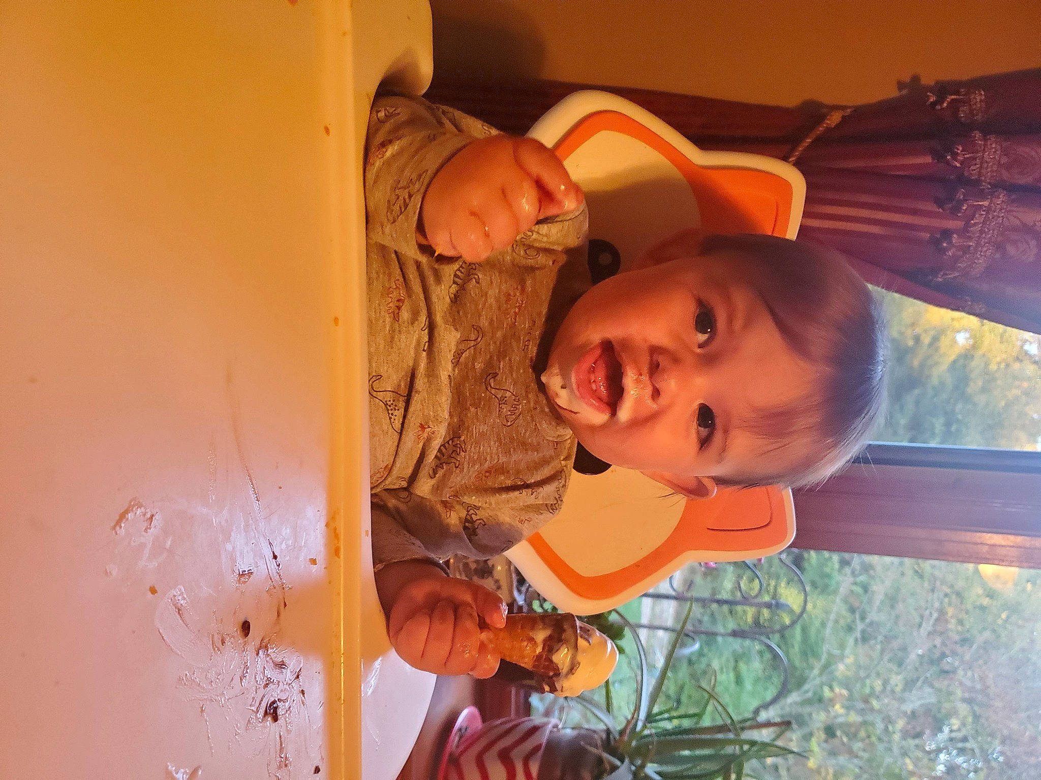 Danny is registered to the contest to win money with this photo: baby, child, fun, grass, happy, hat, mouth, nose, orange, people_in_nature, person, plant, room, smile, sunglasses, toddler, tree, wood