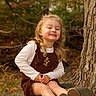 Cadence joined the competition — help win amazing prizes! child, girl, smiling, portrait, outdoor, autumn, forest, woodland, tree, fallen_log, leaves, nature, blonde_hair, dress, shirt, boots, sitting, happy, photography, daylight