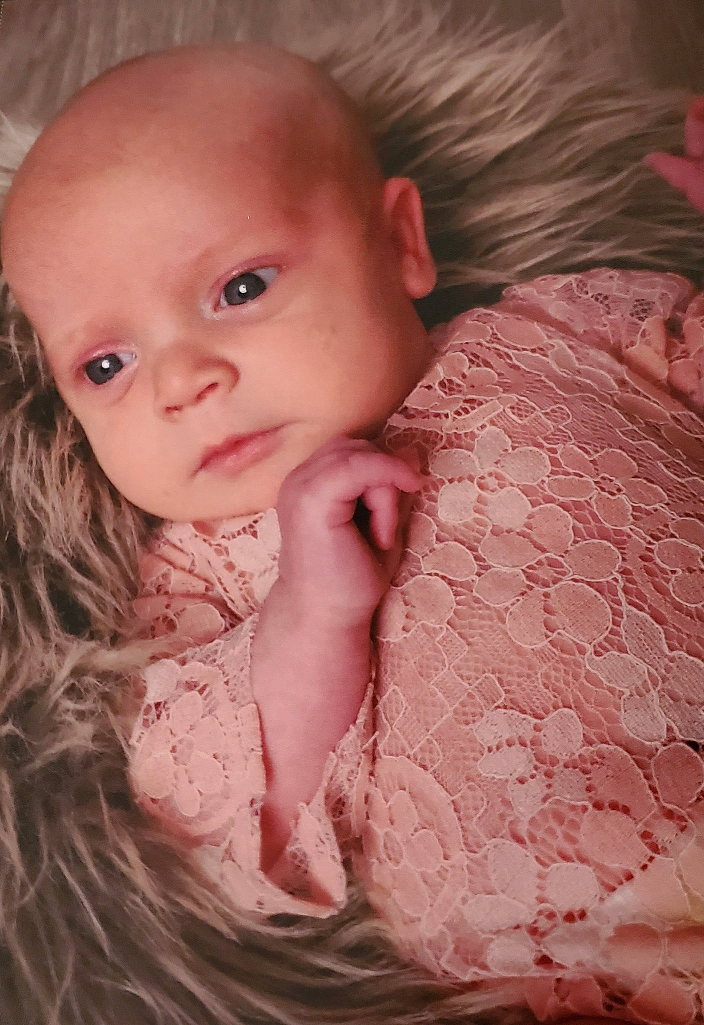 Ophelia is registered to the contest to win money with this photo: baby, baby_toddler_clothing, cheek, chin, comfort, eyebrow, eyelash, finger, flash_photography, gesture, iris, lip, mouth, neck, nose, person, pink, skin, sleeve, textile
