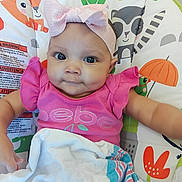 Dream joined the competition — help win amazing prizes! baby, pink_bow, headband, pink_shirt, blanket, baby_seat, animal_pattern, flower_pattern, smile, face, child, infant, cute, indoors, colorful, soft_texture, clothing, person, portrait, happy