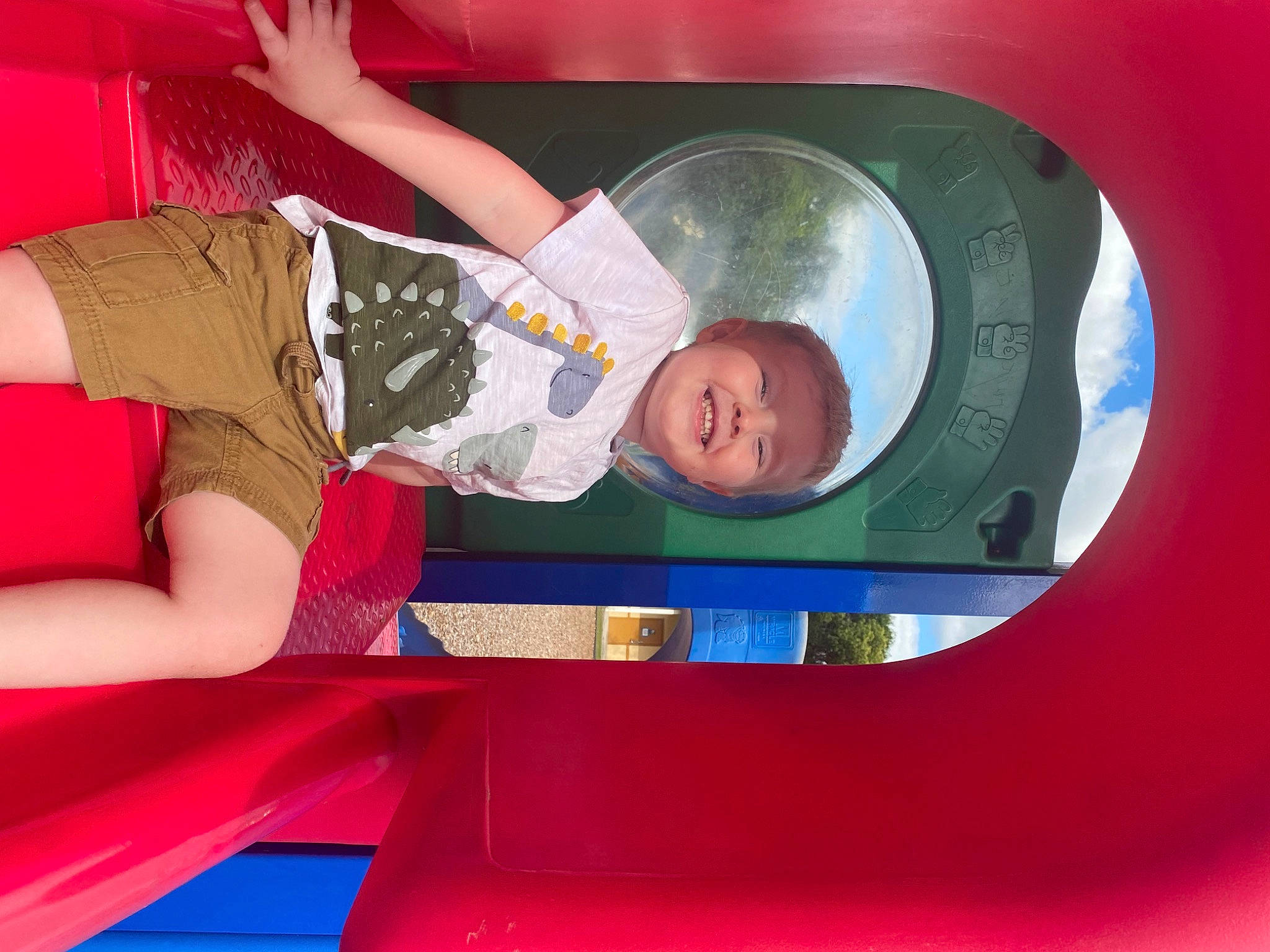 Brenden is registered to the contest to win money with this photo: automotive_design, automotive_exterior, bumper, child, electric_blue, fun, hat, headwear, human_leg, joy, leisure, motor_vehicle, person, personal_protective_equipment, play, playground, recreation, shorts, smile, t_shirt