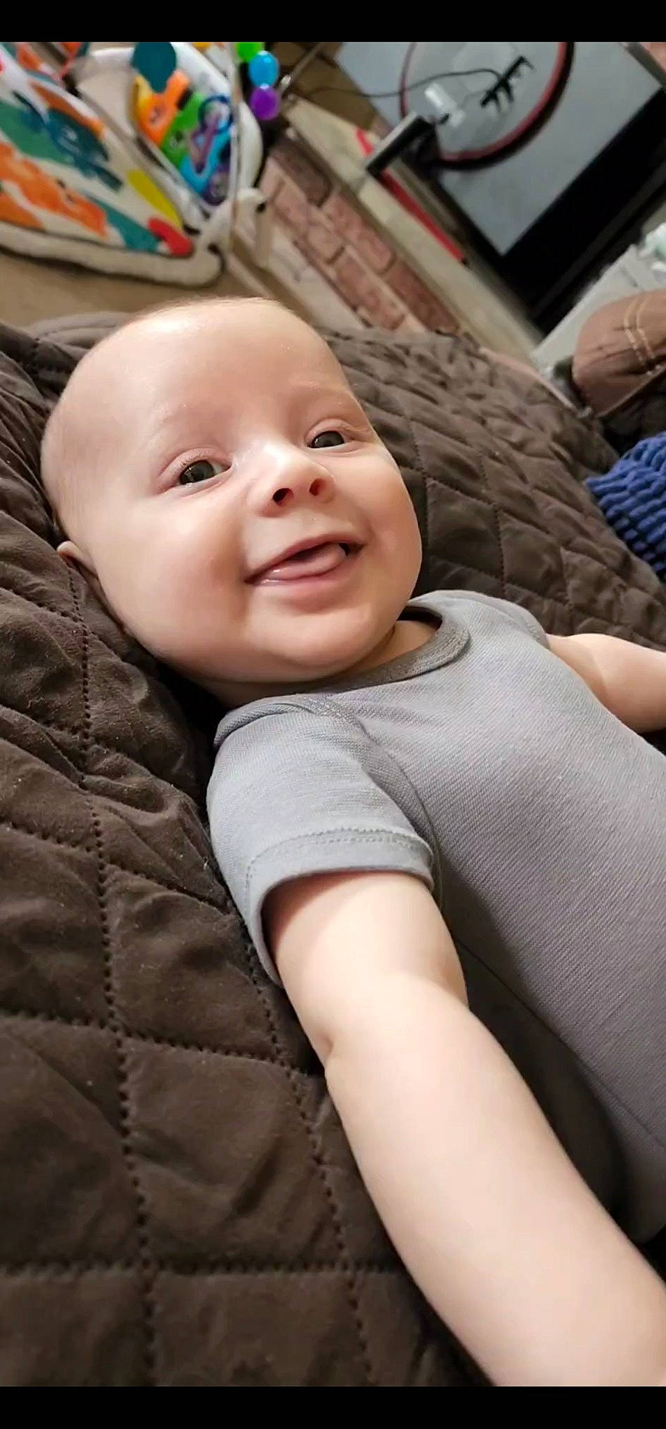 Bentlee is registered to the contest to win money with this photo: baby, cheek, child, comfort, elbow, eye, flooring, happy, head, human_leg, lip, mouth, nose, person, sitting, skin, smile, t_shirt, textile, toddler