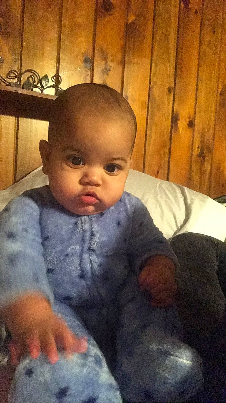 Mikel is registered to the contest to win money with this photo: baby, baby_toddler_clothing, cheek, child, comfort, finger, iris, lip, mouth, person, sitting, skin, toddler