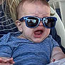 baby, child, sunglasses, striped_shirt, crying, expression, face, indoor, person, head, hair, hand, reflection, clothing, casual, closeup, infant, blue, eyewear, emotion