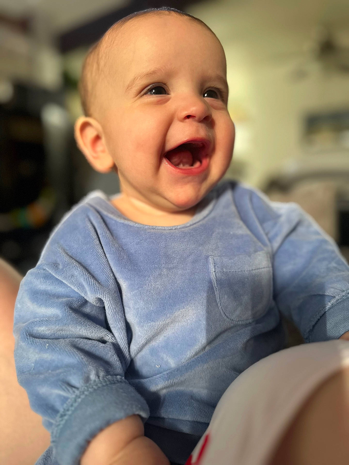 Levi is registered to the contest to win money with this photo: baby, blue_clothing, cheerful, child, closeup, cute, expression, face, happy, head, indoor, infant, mouth_open, person, portrait, sitting, skin, smiling, soft_light, young_child