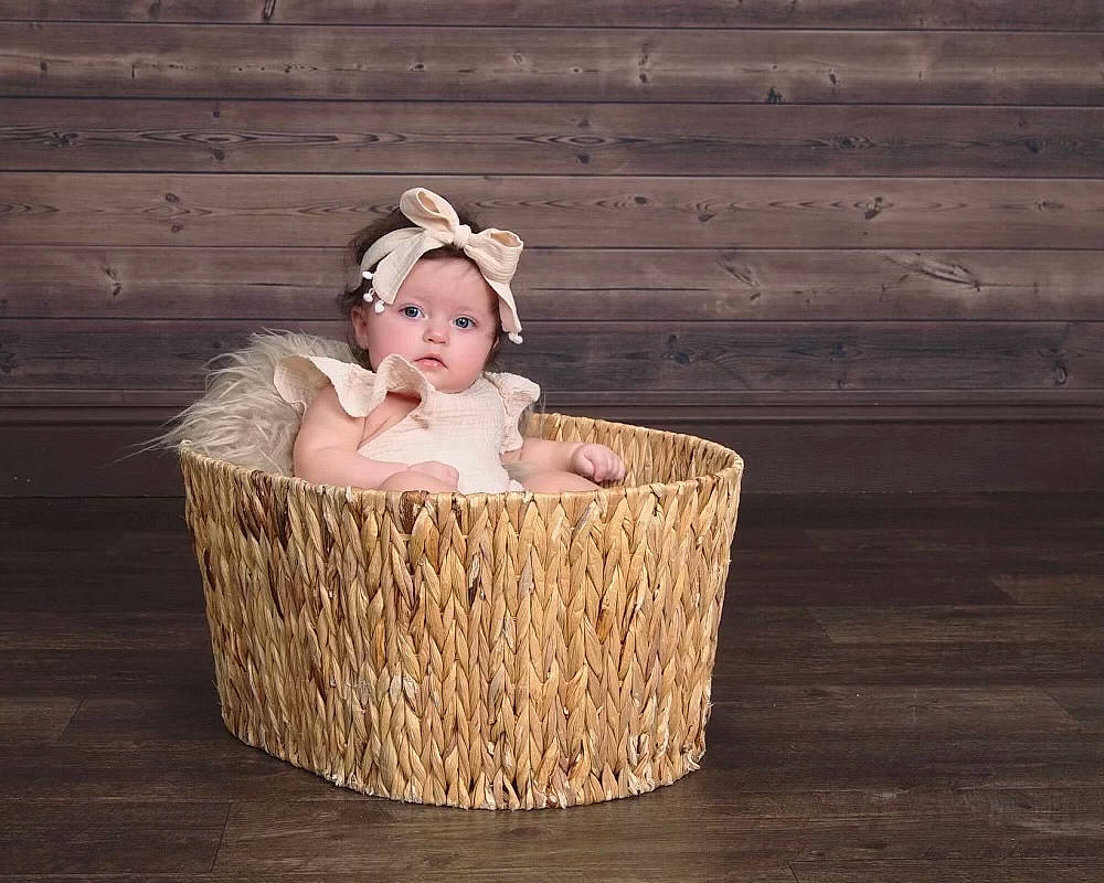 Allison is registered to the contest to win money with this photo: baby, baby_toddler_clothing, basket, child, costume_hat, fashion_accessory, flooring, fur, grass, happy, hardwood, headband, headpiece, headwear, jewellery, person, picnic_basket, storage_basket, toddler, toy