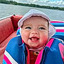 Ariella is registered to the contest to win money with this photo: baby, clothing, coat, face, happy, hat, head, hood, hoodie, jacket, knitwear, lifejacket, person, photography, portrait, smile, sweater, sweatshirt, vest, water