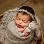 Ariella is registered to the contest to win money with this photo: baby, blanket, bodypart, cap, clothing, face, finger, hand, happy, hat, head, knitwear, newborn, person, photography, portrait, smile, sweater, teddybear, toy