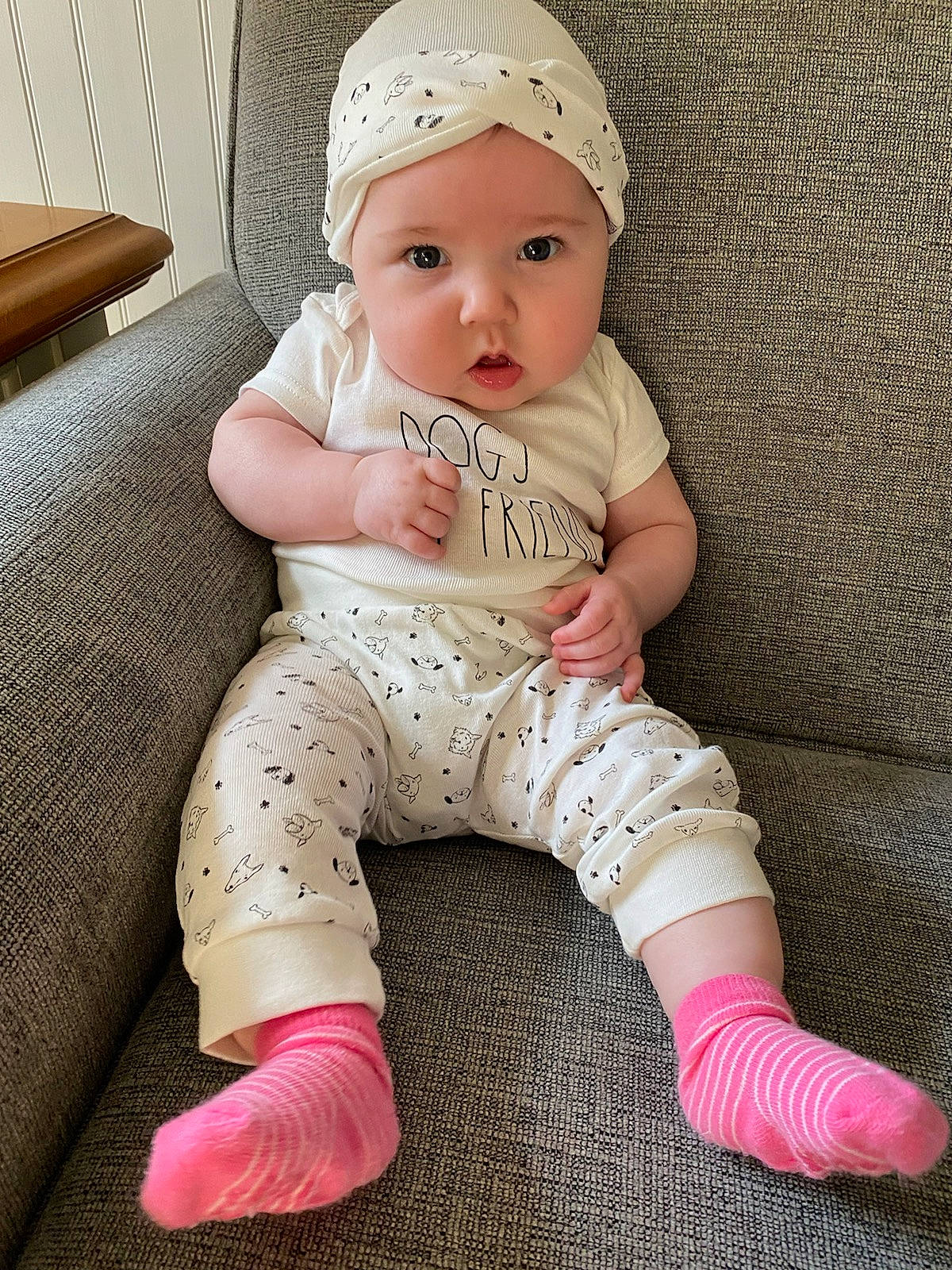 Rosalee is registered to the contest to win money with this photo: baby, baby_toddler_clothing, cap, cheek, child, clothing, comfort, flooring, foot, headwear, human_leg, knee, lip, neck, pattern, person, pink, skin, sleeve, textile