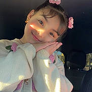 Maribel joined the competition — help win amazing prizes! child, girl, smiling, portrait, car, car_interior, flower_hair_clips, hair_accessories, sweater, knitwear, hands, posing, sunlight, warm_lighting, face, eyes, indoors, happy, fashion, cute