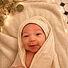 baby, smile, blanket, wrapped, cozy, face, infant, newborn, soft, warm, fairy_lights, eucalyptus, closeup, portrait, cute, happy, skin, indoors, comfort, peaceful