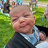 baby, boy, smile, close_up, outdoor, grass, people, lawn_chair, blurred_background, happy, portrait, infant, child, casual_clothing, baby_wrap, daylight, greenery, cute, face, expression