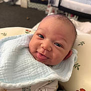 Jaylen joined the competition — help win amazing prizes! baby, infant, smiling, tongue_out, blanket, cozy, indoor, cute, child, face, happy, portrait, soft_lighting, floral_pattern, home, sleepwear, head, expression, newborn, comfort