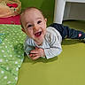 Eden participe au concours pour gagner de l'argent avec cette photo : baby, child, smiling, happy, indoor, green_mat, polka_dot, clothing, pants, long_sleeve_shirt, beanbag, floor, white_chair, play_area, infant, person, cute, hands, face, eyes