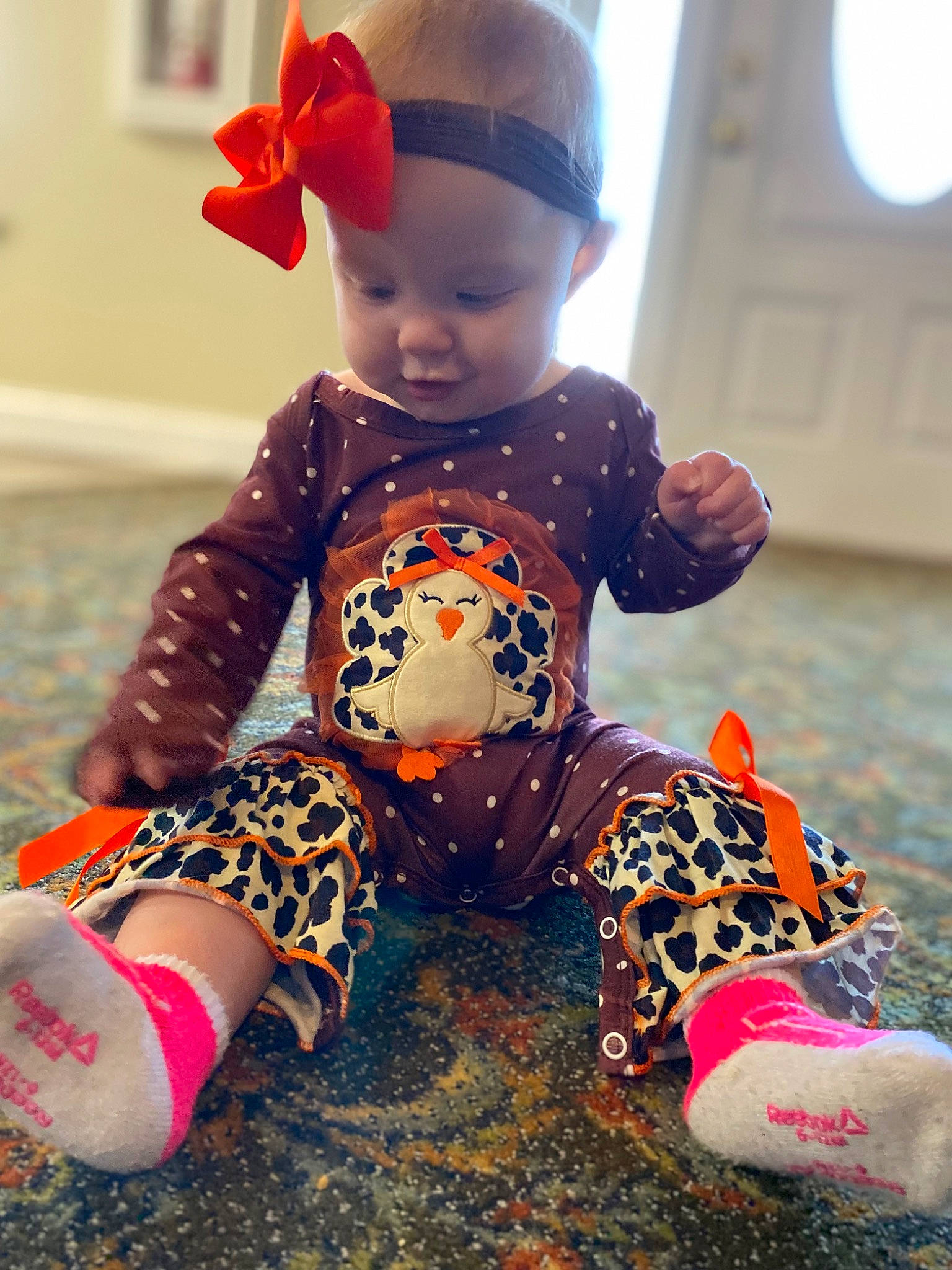Daenerys is registered to the contest to win money with this photo: baby, baby_toddler_clothing, beauty, child, doll, flooring, fun, happy, headwear, joint, mammal, orange, organ, person, pink, red, shoe, skin, sleeve, toddler