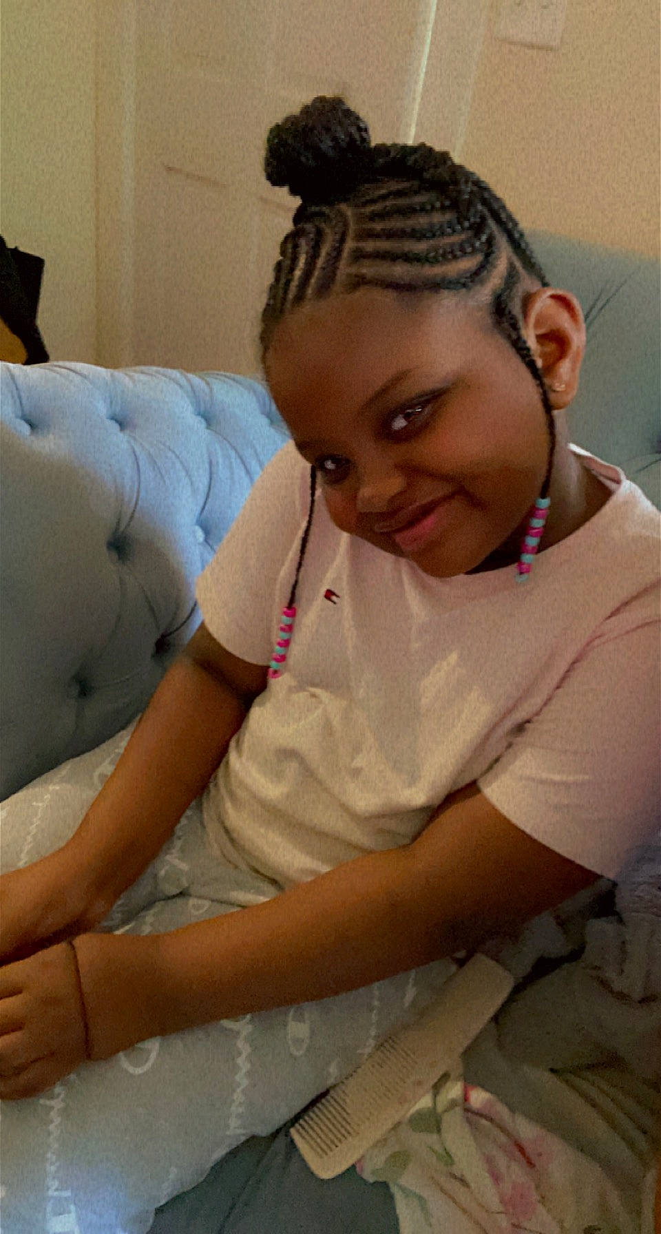 Morgan is registered to the contest to win money with this photo: arm, black_hair, comfort, cornrows, couch, ear, elbow, eye, eyebrow, eyelash, forehead, hair, hairstyle, happy, human_body, joy, neck, person, skin, smile